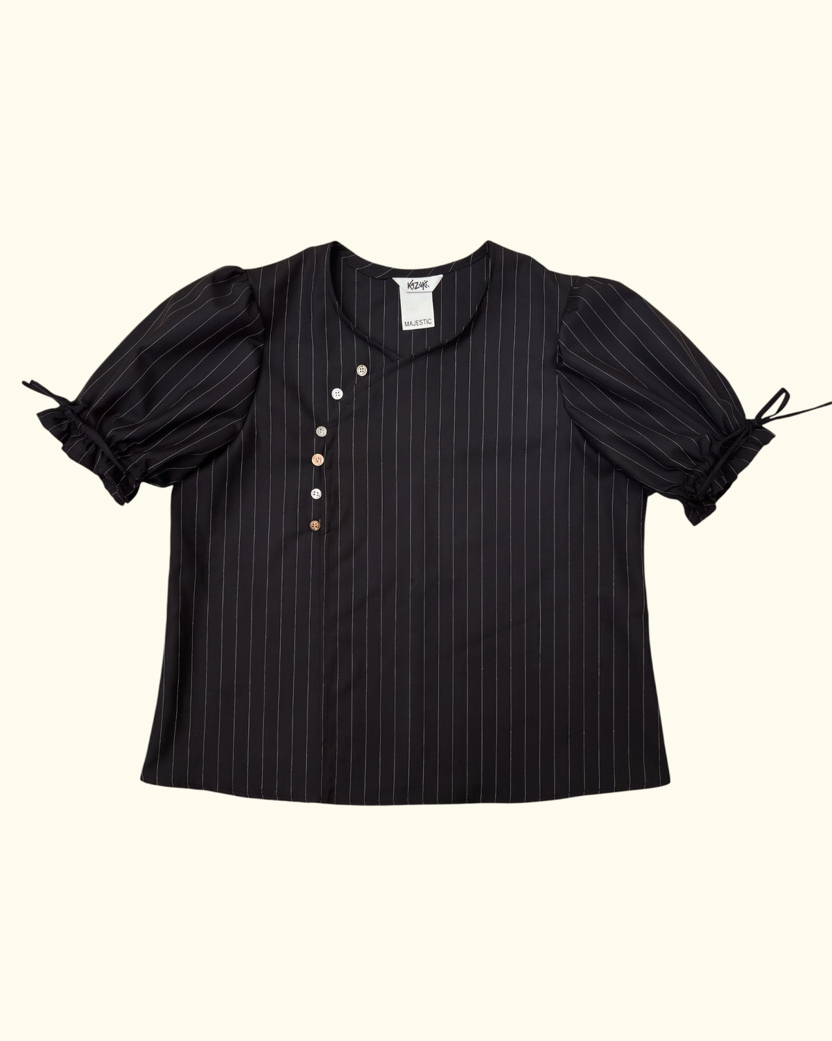 Pinstripe Dolly black wool puff sleeve blouse by Kazuki, front view with mismatched buttons and tie cuffs