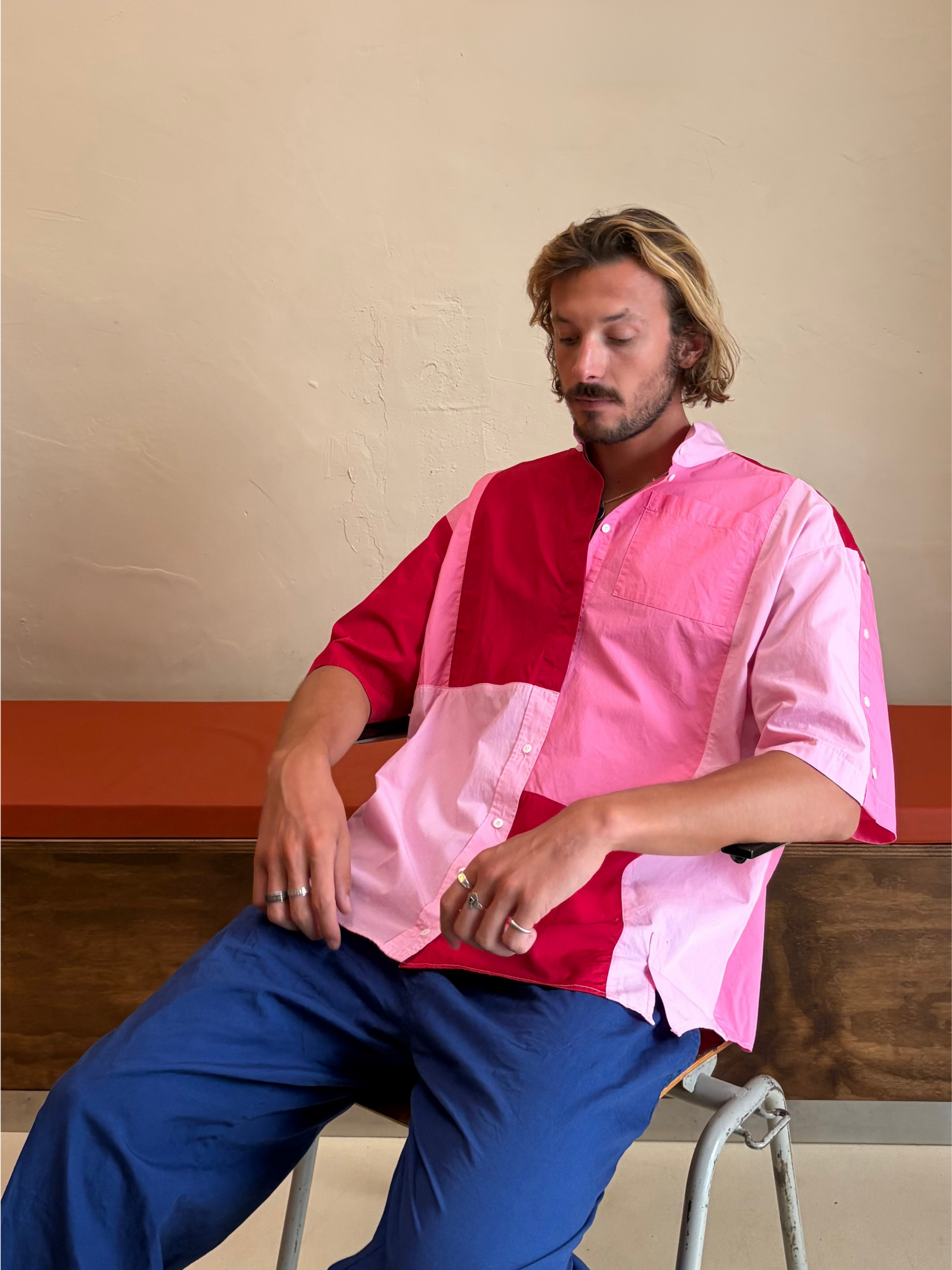 Model wearing The Pink Collision One pink and red upcycled patchwork shirt by Kazuki