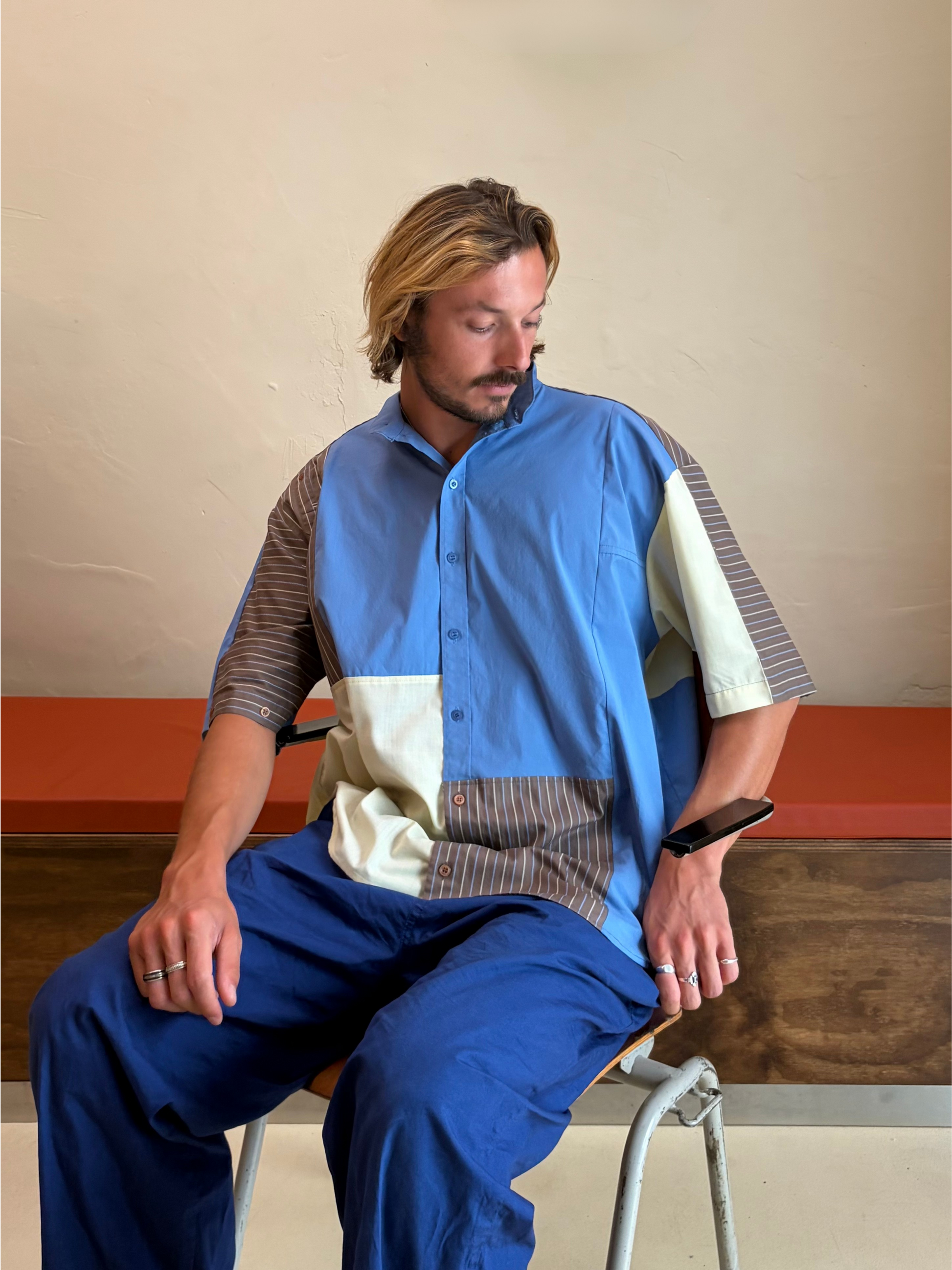 Model wearing The Sand & Sky One blue and beige upcycled patchwork shirt by Kazuki